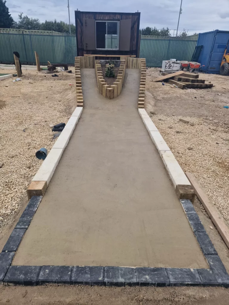 Railway-themed feature being installed on the course