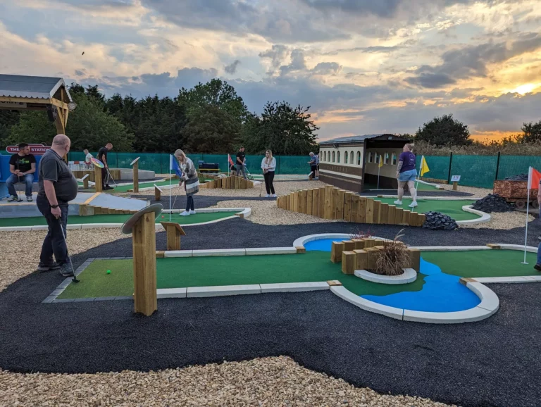 A finished golf hole with railway-inspired scenery